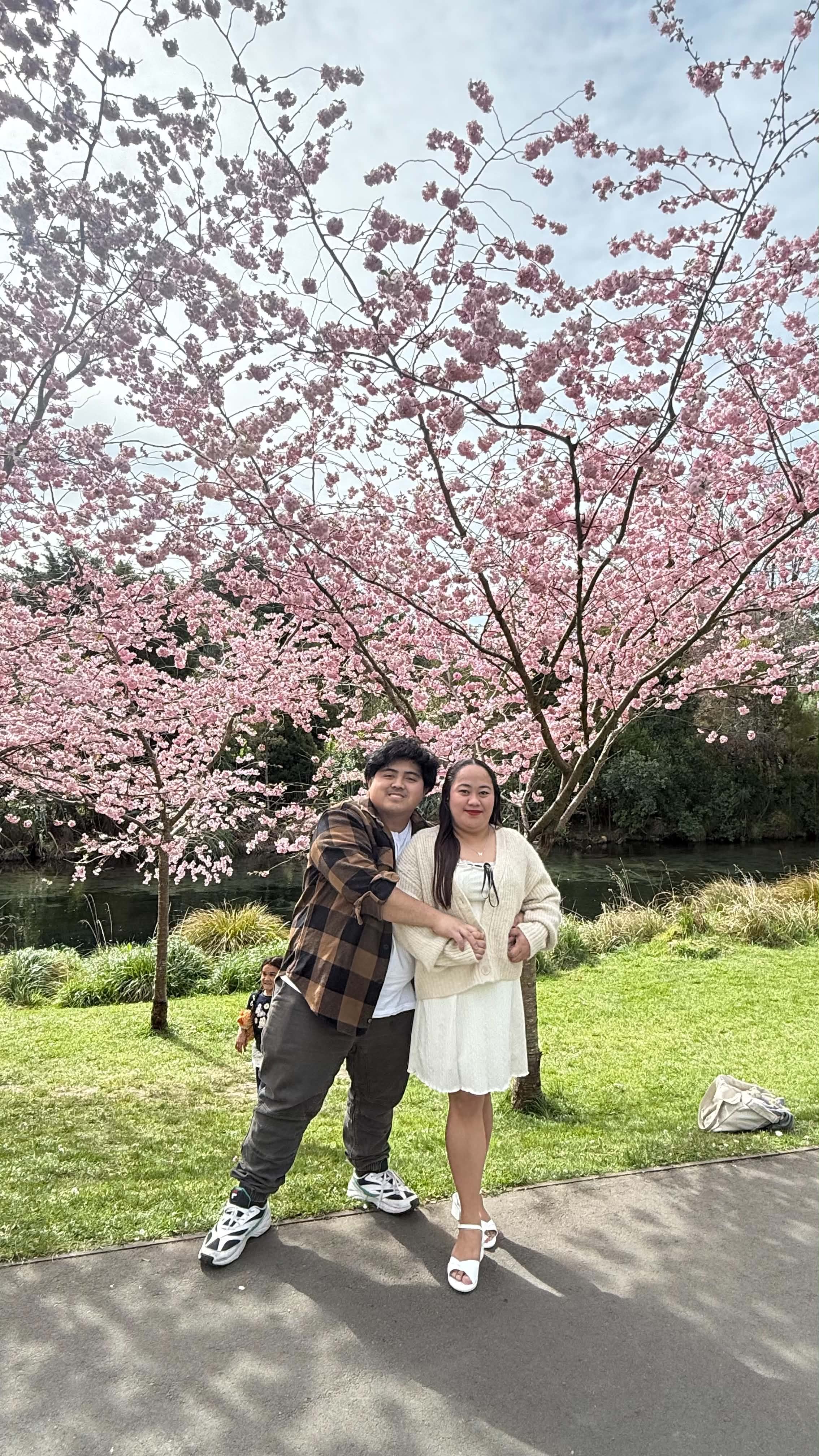 Jhon Aries and Charmnie Jade beneath pink blossoms